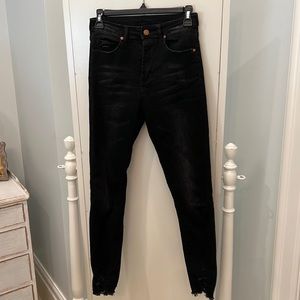Distressed black skinny jeans
